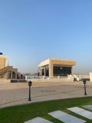 a building with two lights in front of it at Casa Élan for VIP guests 2 Pools in Ras al Khaimah
