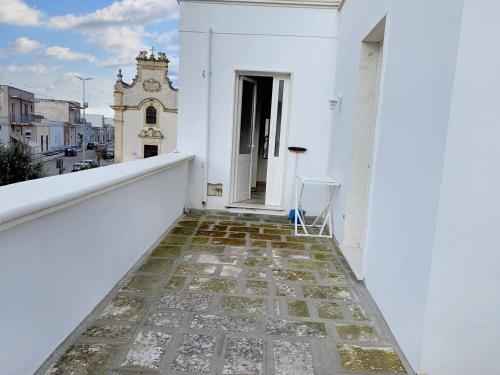 a balcony with a view of a building at One bedroom apartement with furnished terrace and wifi at Melendugno 5 km away from the beach in Melendugno