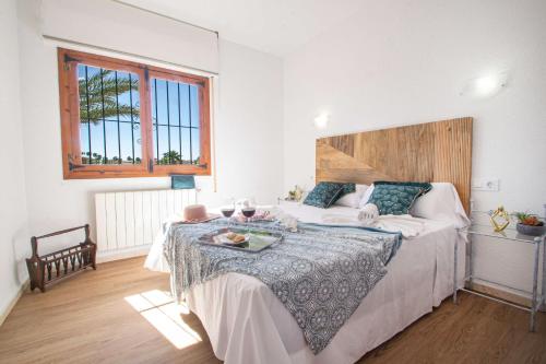 a bedroom with a bed with a table on it at Villa Cohete - Plusholidays in Ifach