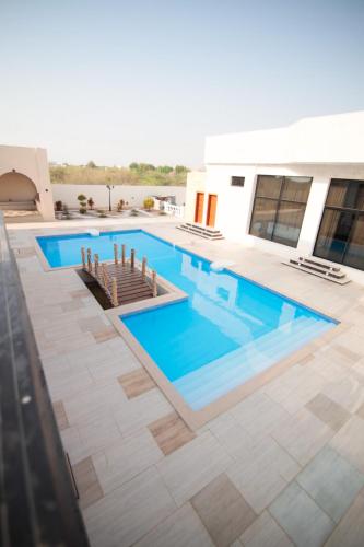 a swimming pool with blue water in a building at Casa Élan for VIP guests 2 Pools in Ras al Khaimah