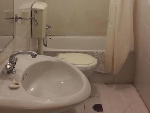 y baño con lavabo blanco y aseo. en Cosy Place, en Luanda
