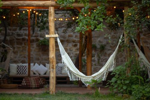 a hammock hanging from a pergola in a garden at HOPESTEL Secret Garden Napoli in Naples