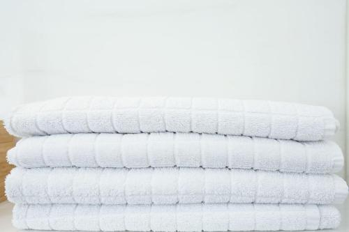 a stack of white towels stacked on top of each other at Freda Residence 2 in Helsinki