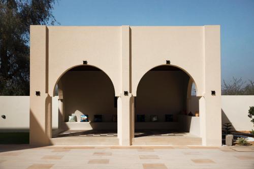 two arches in the courtyard of a building at Casa Élan for VIP guests 2 Pools in Ras al Khaimah