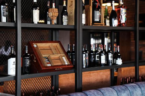 a bar with bottles of wine on shelves at Hotel Frojd - Beach Front Resort in Shëngjin