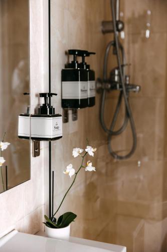 a bathroom with three cameras on the wall next to a sink at Summit Villa in Chişinău
