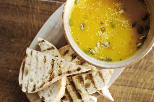 a bowl of soup and tortilla chips on a plate at Tulse Hill Hotel in London