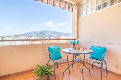 a table and two chairs on a balcony with a view at Apt Parque Fuengirola 800mt From Sea - Happy rentals in Fuengirola