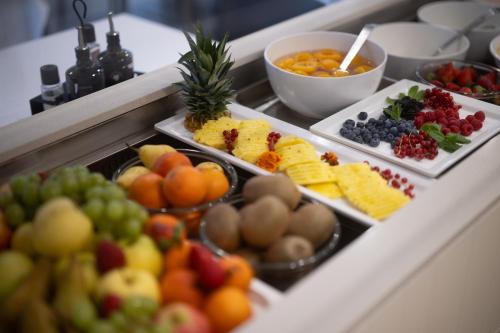 a buffet with many different types of fruits and vegetables at Hotel Bellariva in Riva del Garda