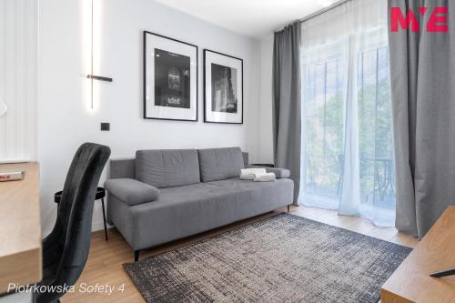 a living room with a couch and a window at MYE Apartments - Piotrkowska 44 in Łódź