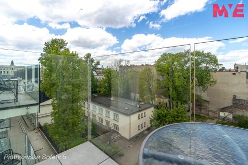 a view of a building from a glass balcony at MYE Apartments - Piotrkowska 44 in Łódź