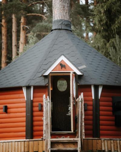a small orange cabin with a black roof at The Mangevie in Furudal