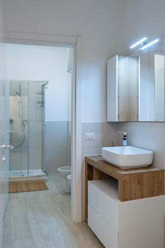a white bathroom with a sink and a shower at Casa Mila in Milan