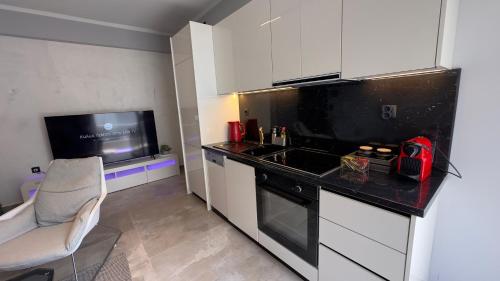 a small kitchen with a sink and a stove at George luxury living in Preveza