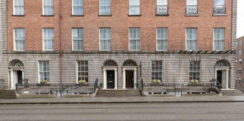 a large brick building with stairs in front of it at Albany Guest House in Dublin