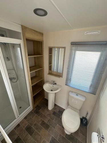 a bathroom with a toilet and a sink at Kingfisher 1004 Keyshare holiday lets 8 Berth in Ingoldmells