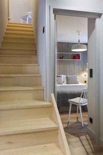 a staircase leading to a bedroom with a bed at Appartements de l'Héliopic in Chamonix-Mont-Blanc