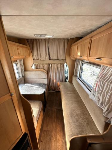 an interior of an rv with a couch and a window at Комфортный семейный автодом на 5 человек in Tbilisi City