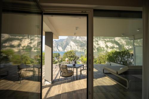 a living room with a view of the mountains at Hotel Bellariva in Riva del Garda