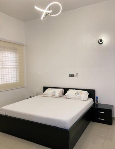 a bedroom with a bed with a ceiling fan at LUXURYs apartment in Abomey-Calavi