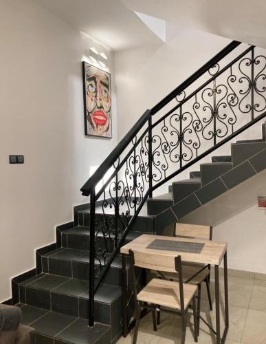 a stairway with a table and a stair railing at LUXURYs apartment in Abomey-Calavi