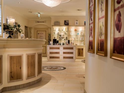 a large room with a counter and a room withartifactsartifactsartifactsartifactsartifactsartifacts at Hotel Alpina Wellness & Spa Resort in Kössen