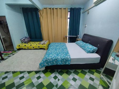 a bedroom with a bed and a couch in a room at Happy Homestay Kebakat Tumpat in Wakaf Baharu