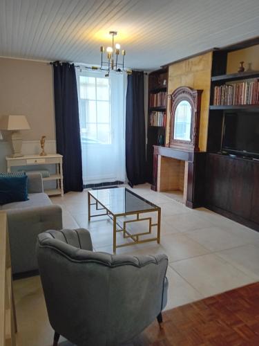 a living room with a couch and a coffee table at Maison de charme-Castillon-St-Emilion in Saint-Magne-de-Castillon