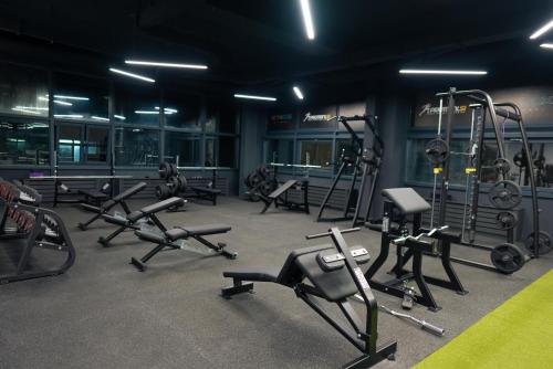 a gym with several treadmills and machines in a room at Avangarda Suites in Belgrade