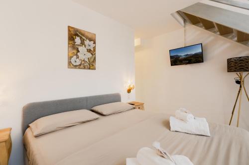 a white room with a bed and a staircase at Garden Apartment in Center - Ambra in Lugano