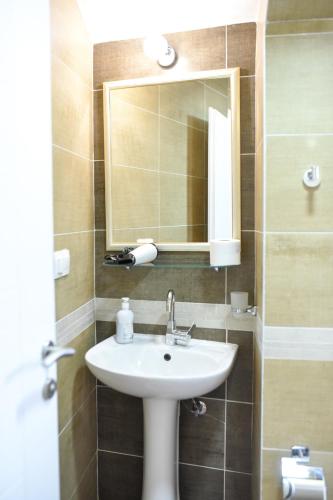 a bathroom with a sink and a mirror at Central Stay Mostar in Mostar
