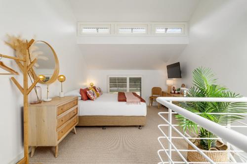 a bedroom with a bed and a mirror at Oceanic Sorrento Apartment 11 in Sorrento