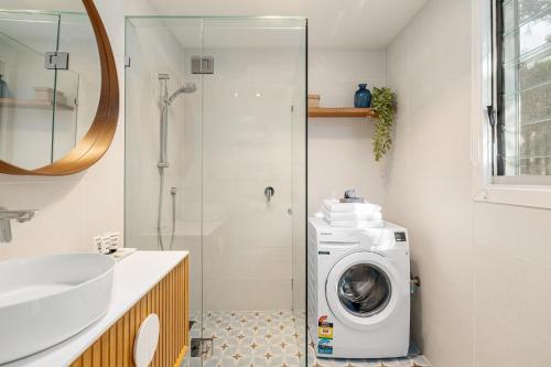 a bathroom with a washing machine and a sink at Oceanic Sorrento Apartment 11 in Sorrento