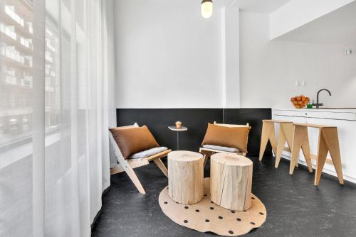a kitchen with two wooden stools and a table at Forenom Aparthotel Oslo in Oslo