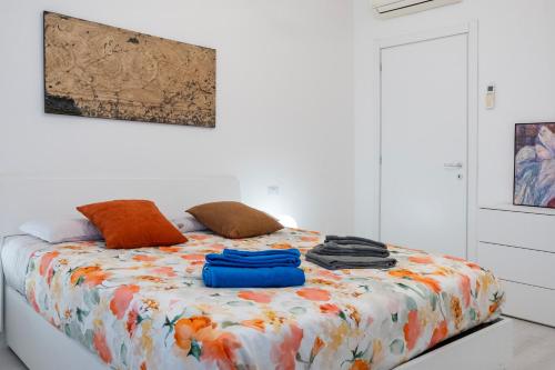 a white room with a bed with an orange at Casa Mila in Milan