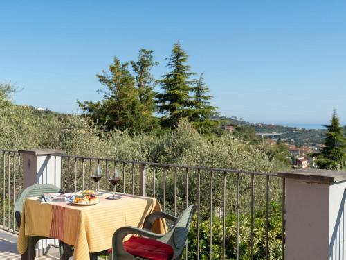 a table and chairs on a balcony with a view at Apartment Casa ai Campi-1 by Interhome in Imperia