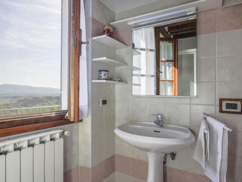 a bathroom with a sink and a window at Holiday Home Le Masse-1 by Interhome in Castelfranco Piandisco