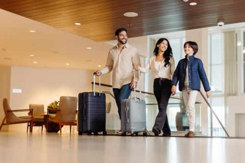 a family walking with their luggage at an airport at Newport Marriott Hotel & Spa in Newport