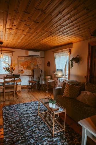 a living room with a couch and a table at The Mangevie in Furudal