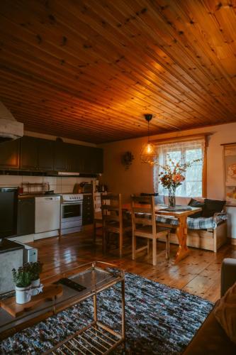 a kitchen and living room with a table and a kitchen and a dining room at The Mangevie in Furudal