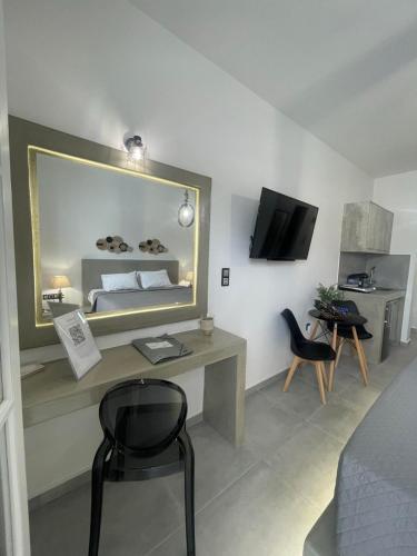 a room with a bed and a desk with a mirror at Zoumis Residence in Naousa