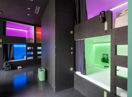 a view of a room with a bed and a room with lights at AMISTAT City Hostel Barcelona in Barcelona