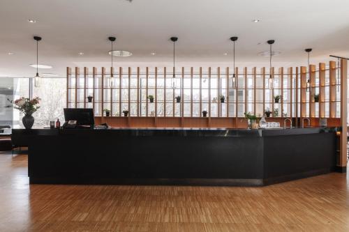 a lobby with a desk with a laptop on it at Clarion Hotel Sign in Stockholm