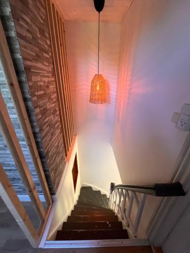 a staircase in a house with a light fixture at Jonas Hus - Munkgaard in Store Heddinge