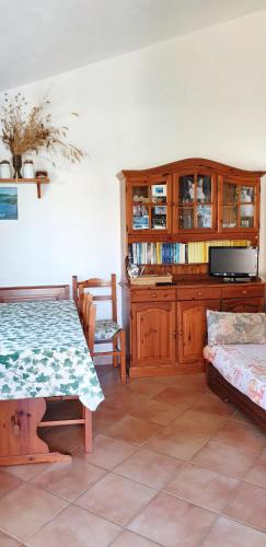 a living room with a table and a cabinet at One bedroom apartement at Lacona 100 m away from the beach with enclosed garden in Lacona