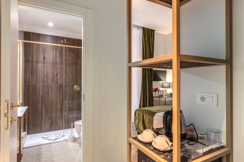 a bedroom with a bed and a bathroom with a mirror at Goldoni 47 in Rome