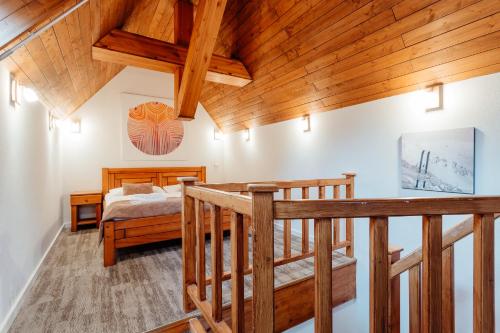a bedroom with a bed and a wooden ceiling at Hotel Mikulášska Chata in Demanovska Dolina