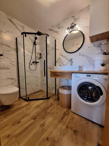 a bathroom with a washing machine and a sink at Apartmani Daria & Jure in Trogir