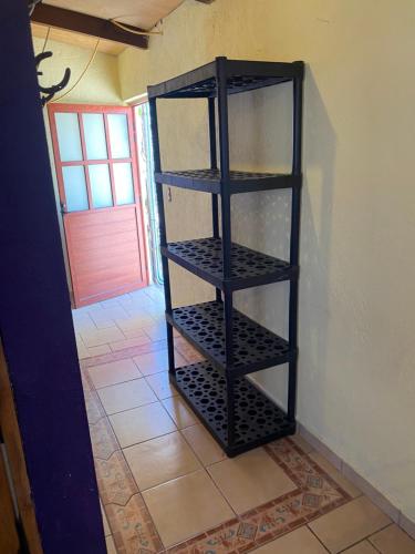 a black book shelf in a room with a door at Granja ENCANES in Irapuato