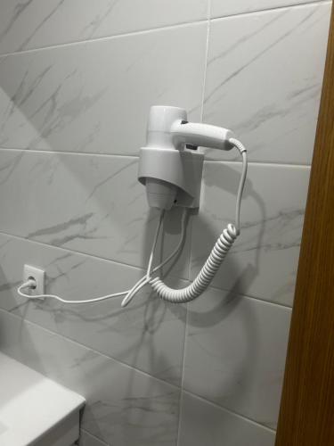 a white phone on a wall in a bathroom at Casa Gidelos in Geres